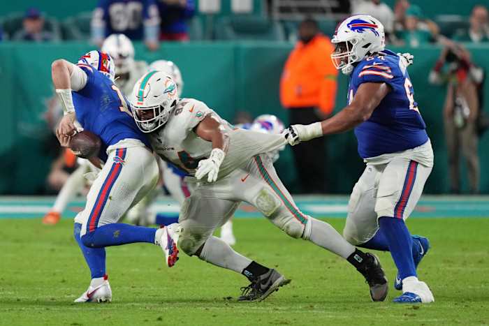 Jan 7, 2024; Miami Gardens, Florida, USA; Miami Dolphins defensive tackle Christian Wilkins (94) strips the ball from Buffalo Bills quarterback Josh Allen (17) as guard O'Cyrus Torrence (64) defends on the play during the second half at Hard Rock Stadium. Mandatory Credit: Jim Rassol-USA TODAY Sports